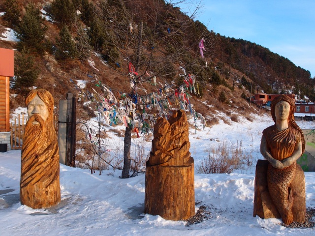 Local carving and tree with prayer flags