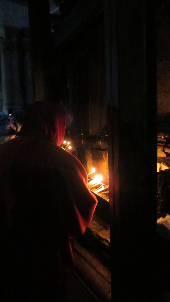 Lighting candles in church of the Holy Sepulcher