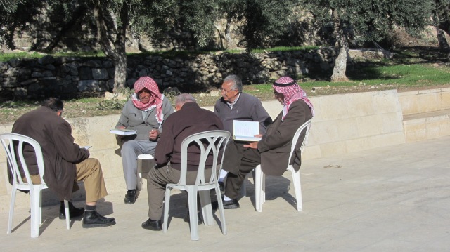 A group of men reading together